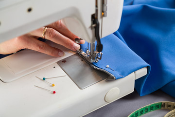 Sewing workshop. Sewing zipper on sewing machine.