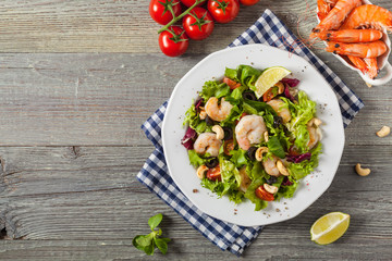 Shrimp salad with tomato, olives and cashew nuts.