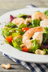 Shrimp salad with tomato, olives and cashew nuts.