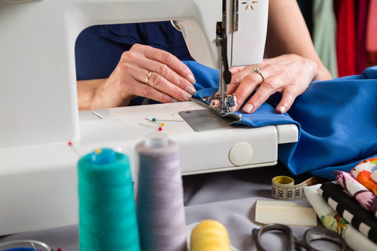Sewing workshop. Sewing zipper on sewing machine.