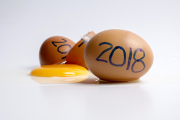 Broken egg with 2017 written and 2018 welcoming years. Happy new years concept.