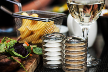 Basket of Fried Chips with a Glass of White Wine and Salt and Pepper