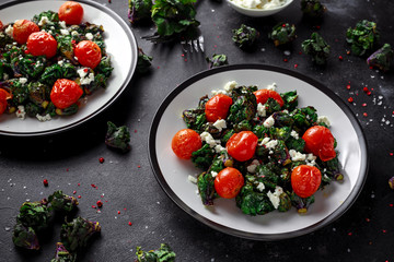 Homemade Roasted Green Kalettes salad with cherry tomatoes and feta cheese. healthy food