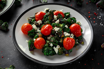 Homemade Roasted Green Kalettes salad with cherry tomatoes and feta cheese. healthy food
