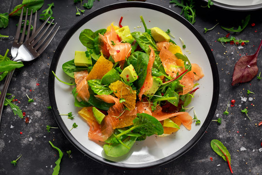 Fresh Salmon Salad With Avocado, Orange And Green Vegetables.