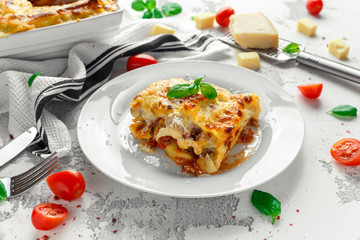 Homemade lasagna with minced beef bolognese and bechamel sauce topped wild arugula, parmesan cheese