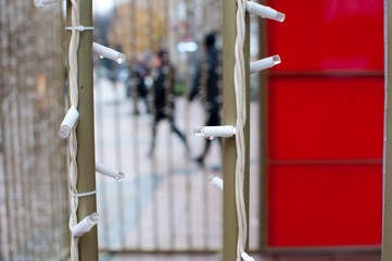 isolated little lights as decoration on rainy day with blurred street  background