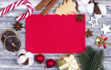 Christmas greeting card red, candy cane orange star, anise cinnamon gray background, wooden fir branches.