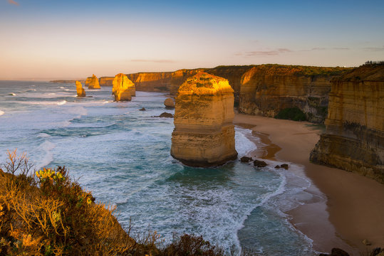 Sunrise over Twelves Apostles in Great Ocean Road, Victoria, Australia. The Twelve Apostles is a collection of limestone stacks off the shore of the Port Campbell National Park.