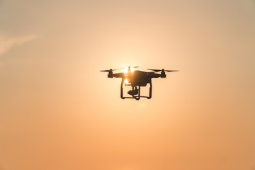 The drone in the sunset sky. ocean wave mountains Close up of quadrocopter outdoors. concept for film maker wedding videography aerial photographer. equipment for vlog blog, old,