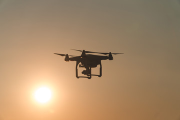 The drone in the sunset sky. ocean wave mountains Close up of quadrocopter outdoors. concept for film maker wedding videography aerial photographer. equipment for vlog blog, old,