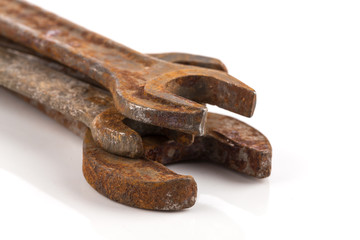 old rusty spanners on white background