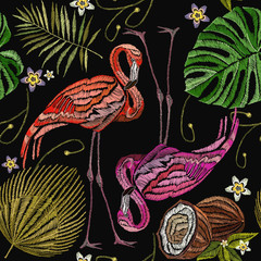 Fototapeta premium Embroidery flamingo , palm tree leaves, coconut tropical seamless pattern. Fashionable embroidery pink flamingos, tropical summer background. Fashionable template for design of clothes