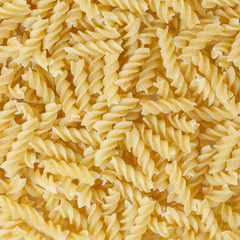 Uncooked rotini pasta background