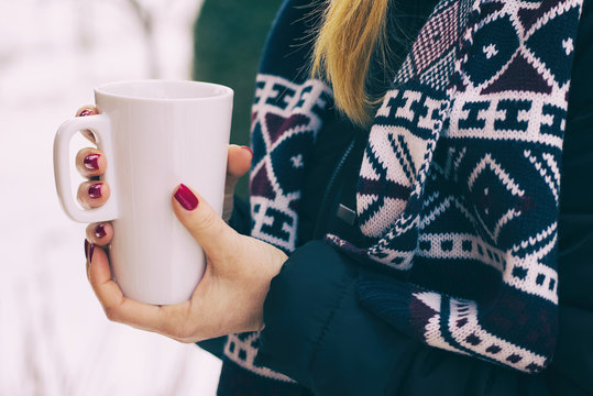 Woman Holding A Steaming Cup Of Hot Coffee In Her Hands Outdoors In Winter, Numbed Female Hands With Polished Nails 