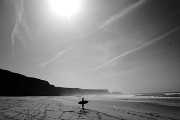 Surfer on lonely beach