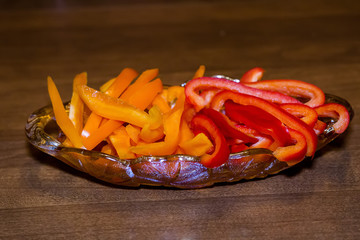 sliced orange and red bell peppers in a dish