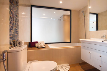 Luxury bathroom features basin, toilet bowl and bathtub