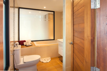 Luxury bathroom features basin, toilet bowl and bathtub