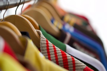 A hanger with multi coloured clothes 