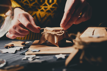 Female hands cooking orange jam for Christmas gifts