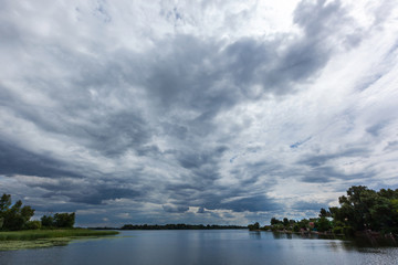 Fototapeta na wymiar stormy clouds over the river, beautiful clouds over the water