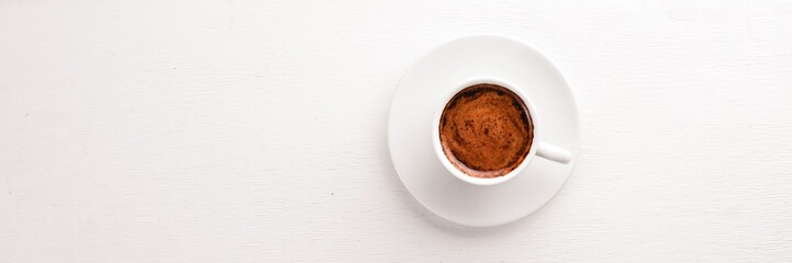 Espresso coffee cup on a white wooden background. Top view. Free space for text.