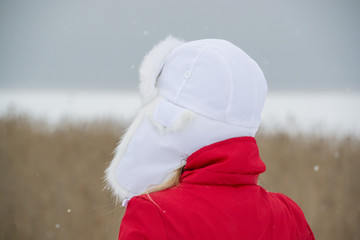 Woman Wearing a White Hat and Red Jacket Outdoors in Winter