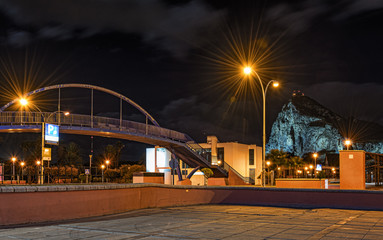 Night photo of small bridge with rock of Gibraltar on a background. Photo made from Spanish town La Linea de la Concepcion. 