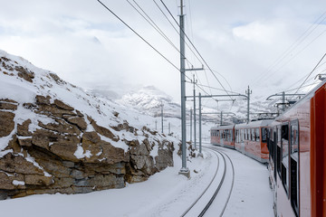 Red train of Gornergrat bahn with snow around