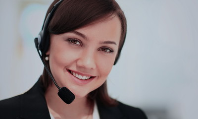 Portrait of happy smiling cheerful support phone operator in headset at office
