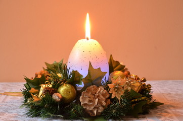 Holy Christmas crown with burning candle