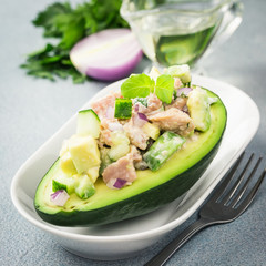 Mexican tuna avocado salad on concrete background. Selective focus, copy space.
