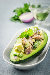 Tuna spinach avocado salad on concrete background. Selective focus, copy space.