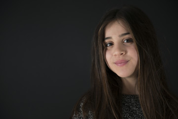 Fototapeta premium Portrait of a nice little girl on a black background