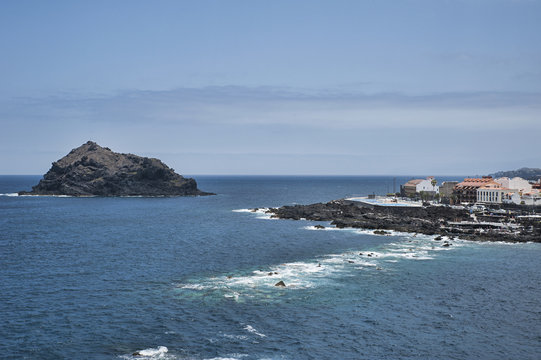 The quaint Garachico village, popular tourist attraction, with its natural sea water pools, beautiful architecture and distinct rock emerging from the ocean, in Tenerife, Canary Islands, Spain