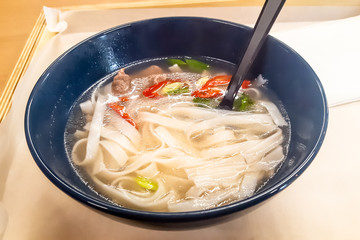 Traditional Vietnamese soup with beef and pasta - fo in a black plate