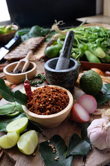 Assortment of Thai food Cooking ingredients. Spices ingredients chilli pepper garlicgalanga and kaffir lime leaves.
