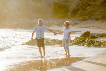 lovely senior mature couple on their 60s or 70s retired walking