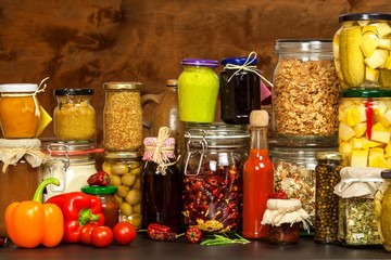 Ingredients for cooking on a wooden table. Glass of cooked vegetables and jam. Chef's workplace.