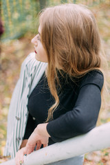 Obraz premium portrait of a luxurious, beautiful, young girl. Dressed in stylish clothes, walking in an autumn park. Bright lipstick on the lips.