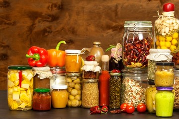 Ingredients for cooking on a wooden table. Glass of cooked vegetables and jam. Chef's workplace.