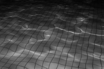 Water in a night pool with a square tile - black and white