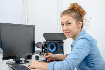 Naklejka premium young woman designer using graphics tablet for video editing