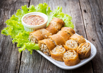 Fried spring rolls. Sliced spring roll served with sweet and spicy sauced. Asian vegetarian appetizer.