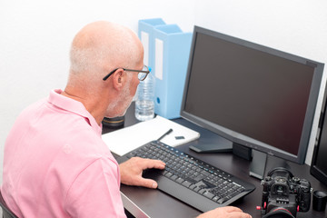 mature man working with computer at office