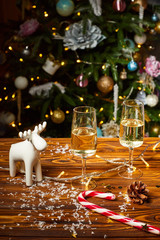 Christmas toy deer decorations on the table with champagne