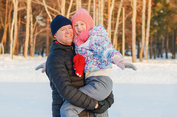 Fototapeta na wymiar Father and daughter ice skating