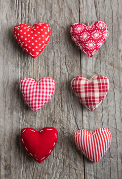 Various hearts on wooden surface