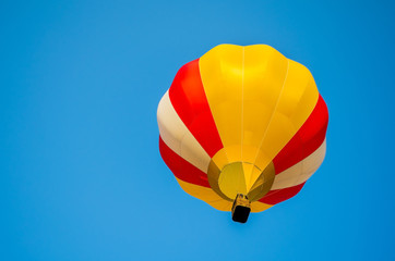 Colorful hot air balloon on a blue sky background